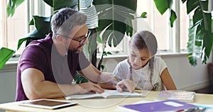 Dad, kid and homework for school, learning and education with book, help and parenting. Homeschool, parent and reading