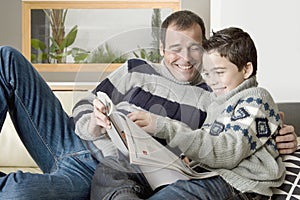 Dad and kid reading magazine