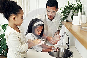 Dad, kids and washing hands in bathroom with soap at tap teaching girls hygiene on morning routine. Water, soap and man