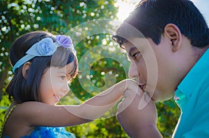 Dad kissing dauther hand