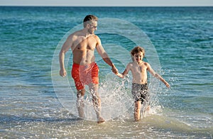 dad man and son kid running in sea beach. Father son bonding enjoying summer vacation. Shared interests. Special moments