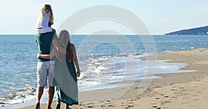 Dad mom and daughter walk along the beach