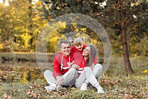 Dad, mom and little cute daughter having fun and playing in the autumn park. family concept, father`s, mother`s and baby`s day