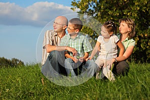 Dad, mom, son and daughter in early fall park