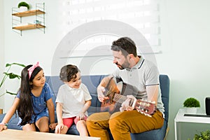 Dad musician teaching a song to his kids