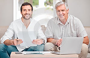 Dad needed a little help with the finances. Cropped portrait of a handsome young man helping his senior father with the