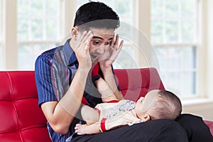 Dad play peekaboo with his baby