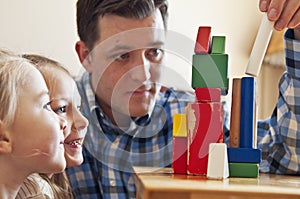 Dad playing with blocks with children