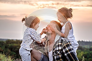 Dad playing with two little cute daughters