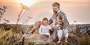 Dad playing with two little cute daughters