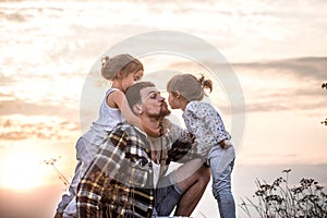 Dad playing with two little cute daughters