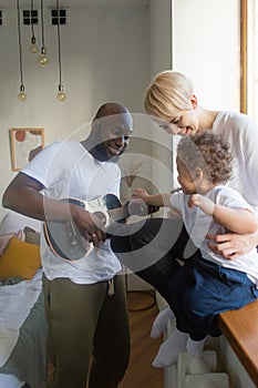 Dad plays guitar to little son