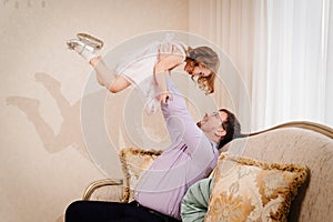 dad plays with his daughter and tosses her up. paternal love. photo