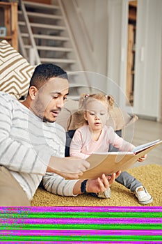 Dad Reading Book to Cute Daughter