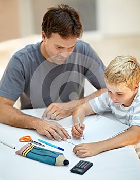 Dad is always ready to help - Single father. Young father helping his son with his school homework.