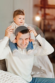 Dad riding his young son on shoulders.