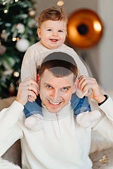 Dad riding his young son on shoulders.