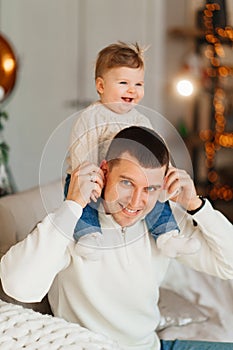 Dad riding his young son on shoulders.