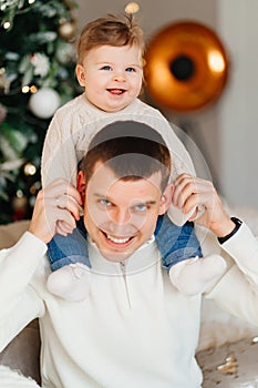 Dad riding his young son on shoulders.