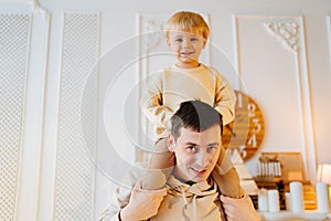 dad rolls his son on his shoulders. father-child games.