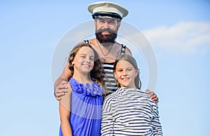 Dad sailor and daughters outdoors. Captain welcome on board. Marine tour. Sea cruise. Handsome bearded sailor with kids