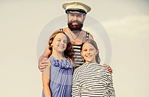 Dad sailor and daughters outdoors. Captain welcome on board. Marine tour. Sea cruise. Handsome bearded sailor with kids