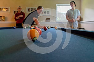 Dad shooting pool with his sons