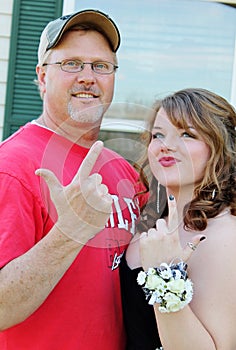 Dad showing finger gun to Daughters Prom date