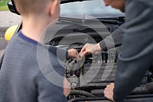 Dad shows his little happy son how the car works