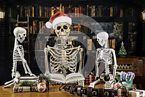Dad skeleton reading to children on Christmas eve in old library photo
