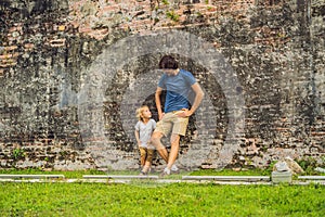 Dad and son on background of Fort Cornwallis in Georgetown, Penang, is a star fort built by the British East India Company in the