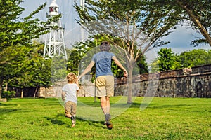 Dad and son on background of Fort Cornwallis in Georgetown, Penang, is a star fort built by the British East India Company in the