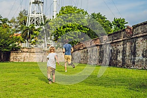 Dad and son on background of Fort Cornwallis in Georgetown, Penang, is a star fort built by the British East India Company in the