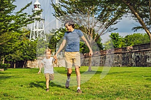 Dad and son on background of Fort Cornwallis in Georgetown, Penang, is a star fort built by the British East India