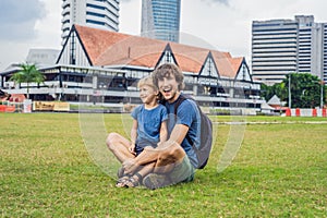 Dad and son on background of Merdeka square and Sultan Abdul Sam