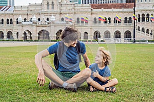 Dad and son on background of Merdeka square and Sultan Abdul Sam