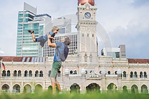 Dad and son on background of Merdeka square and Sultan Abdul Sam