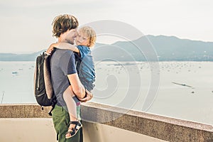 Dad and son in the background of Tropical beach landscape panorama. Beautiful turquoise ocean waives with boats and sandy