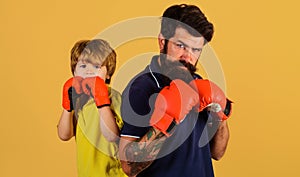 Dad and son in boxing gloves ready for sparring. Training together. Family workout. Sport lifestyle.