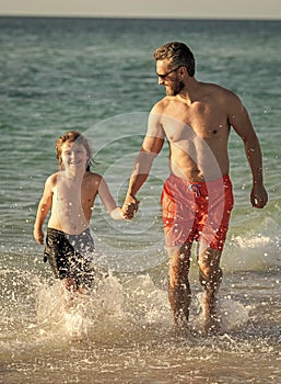 dad and son child has special moments at sea. Father son adventures. dad man and son kid running in sea beach. Father