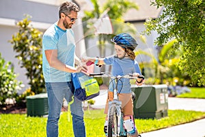 dad and son with childhood togetherness. Father and son sharing biking childhood. Encouraging active participation