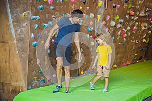 Dad and son at the climbing wall. Family sport, healthy lifestyle, happy family