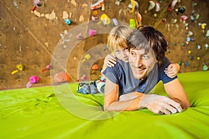 Dad and son at the climbing wall. Family sport, healthy lifestyle, happy family