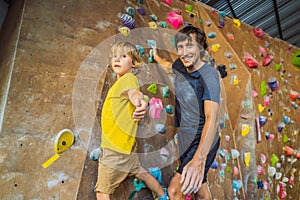 Dad and son at the climbing wall. Family sport, healthy lifestyle, happy family