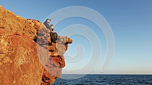 dad and son contemplate the beauty of nature. Freedom. Cinematic look. A man with child on the beach looks into the