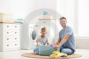 Dad and son doing laundry
