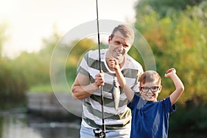 Dad and son fishing together