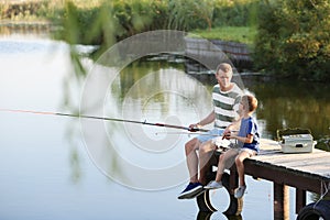 Dad and son fishing together