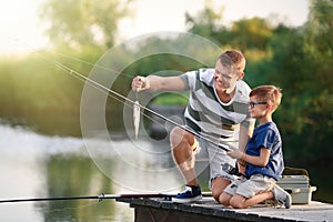 Dad and son fishing together