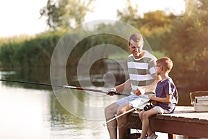 Dad and son fishing together